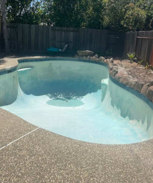 A small pool with a rock wall around it