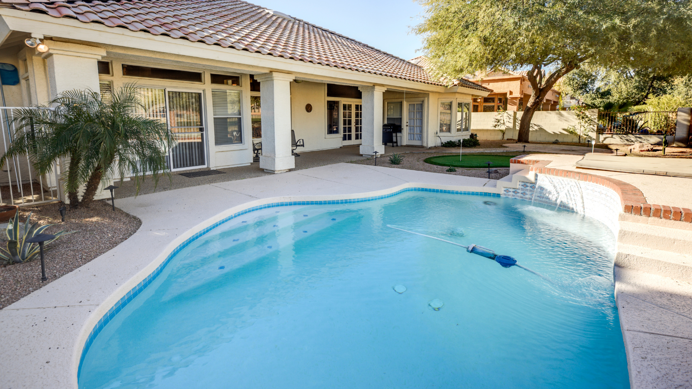 A swimming pool in front of a house