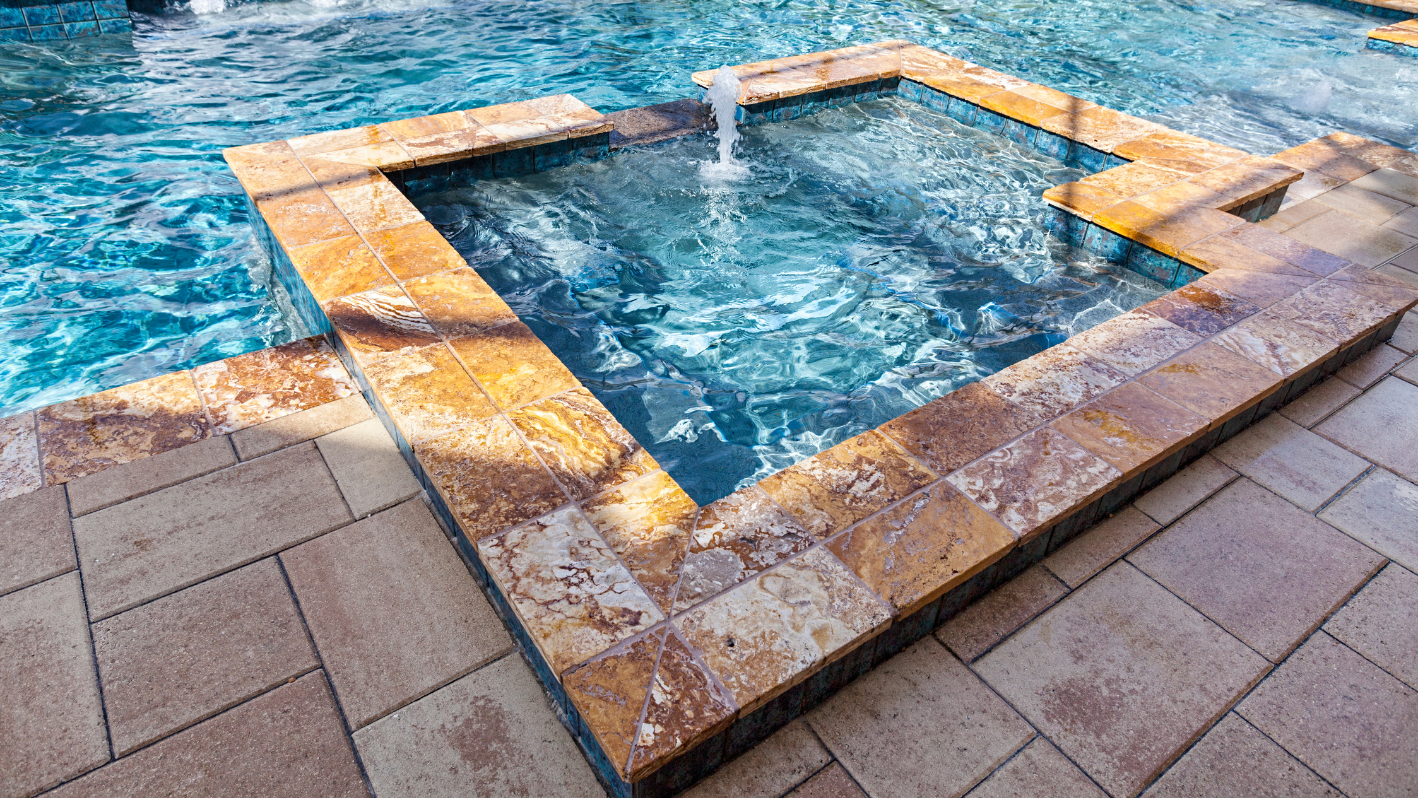 A swimming pool with a fountain in the middle of it