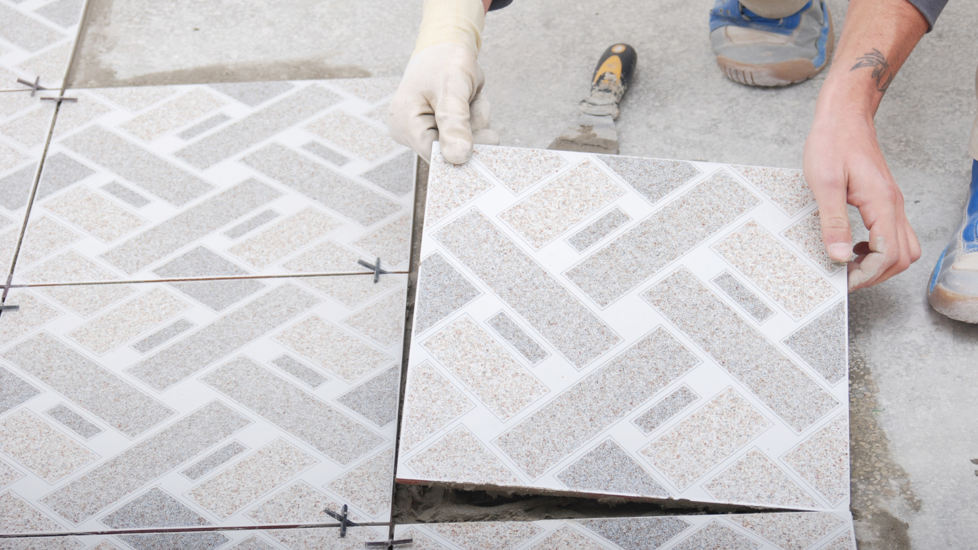 A person is working on a tile floor